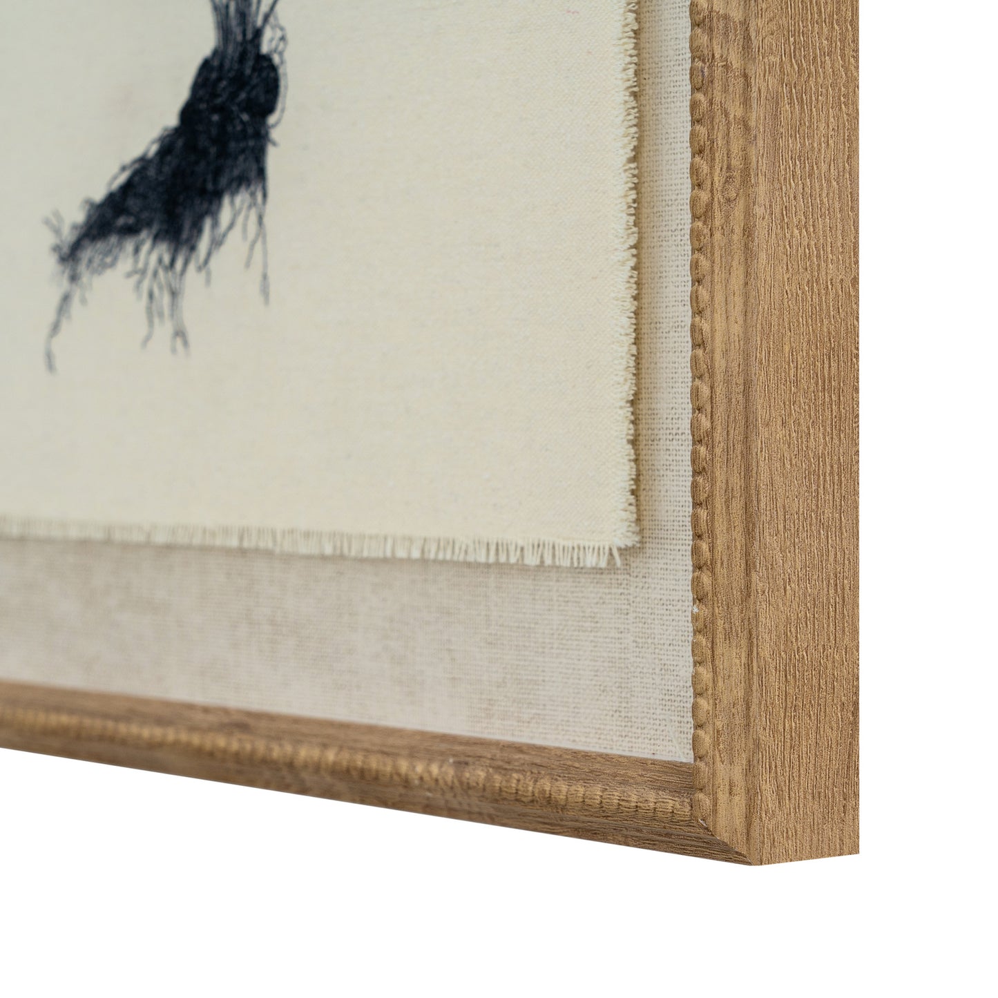 Close-up of a framed painting with a wooden frame and textured wall background