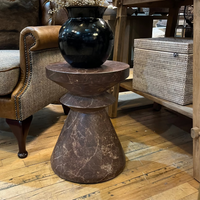 Decorative vase on a marble side table in a living room setting.