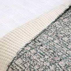 Close-up of a textured fabric with a white and gray pattern