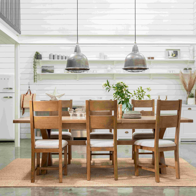 Dining area with wooden table and chairs in a modern kitchen.