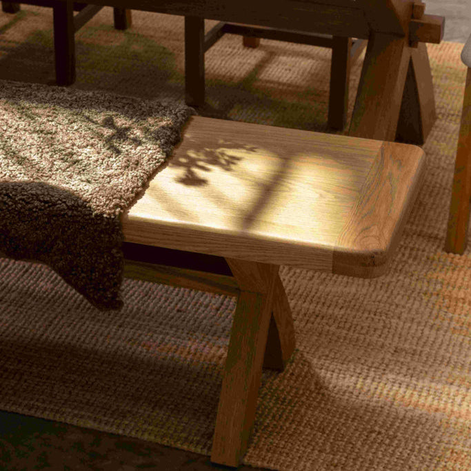Wooden dining table with chairs on a textured rug