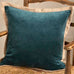 Blue pillow on a wooden chair with a neutral background