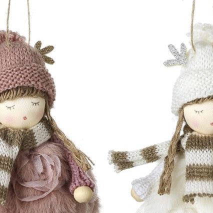 Two decorative dolls with winter outfits hanging against a white background