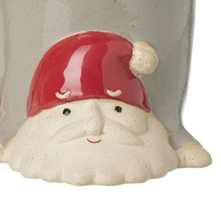 Ceramic mug shaped like a gnome with a red hat on a white background