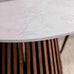 Close-up of a marble table with a vase on it, featuring a modern design.