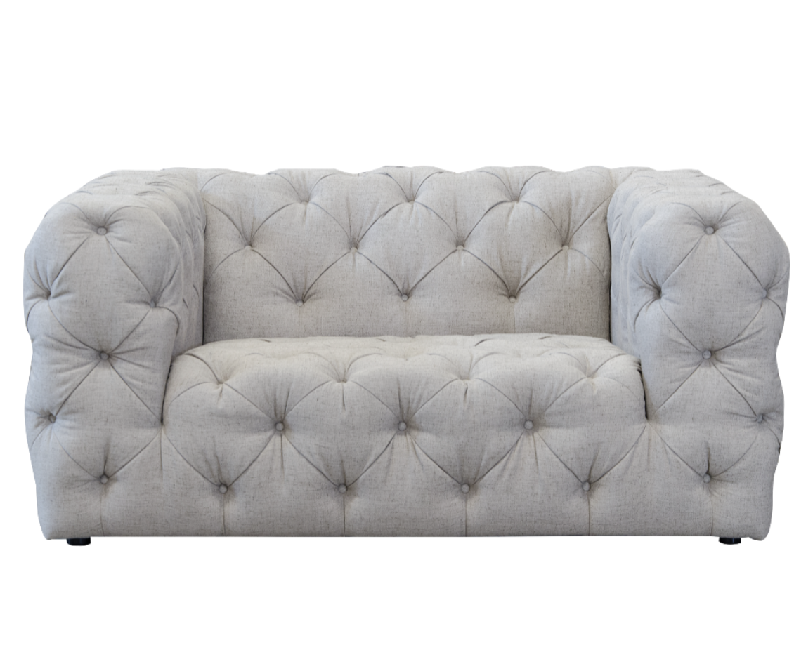 white buttoned snuggler sofa