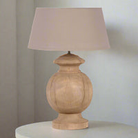 Wooden table lamp with a beige lampshade on a white background