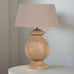 Wooden table lamp with a beige lampshade on a white background