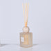 Diffuser with wooden sticks on a light gray background