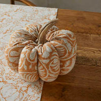 Decorative pumpkin on a marble surface with a wooden background