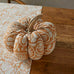 Decorative pumpkin on a marble surface with a wooden background