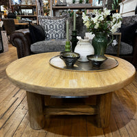 Wooden coffee table with decorative items in a living room setting