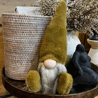 Gnome figurine on a round wooden table with decorative elements in the background
