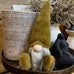 Gnome figurine on a round wooden table with decorative elements in the background