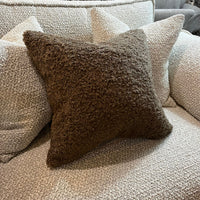 Brown textured pillow on a beige sofa