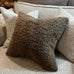Textured pillows on a sofa with a neutral color palette