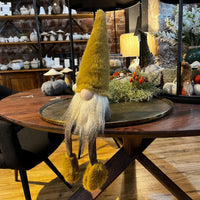 Decorative gnome on a wooden table with a cozy indoor setting
