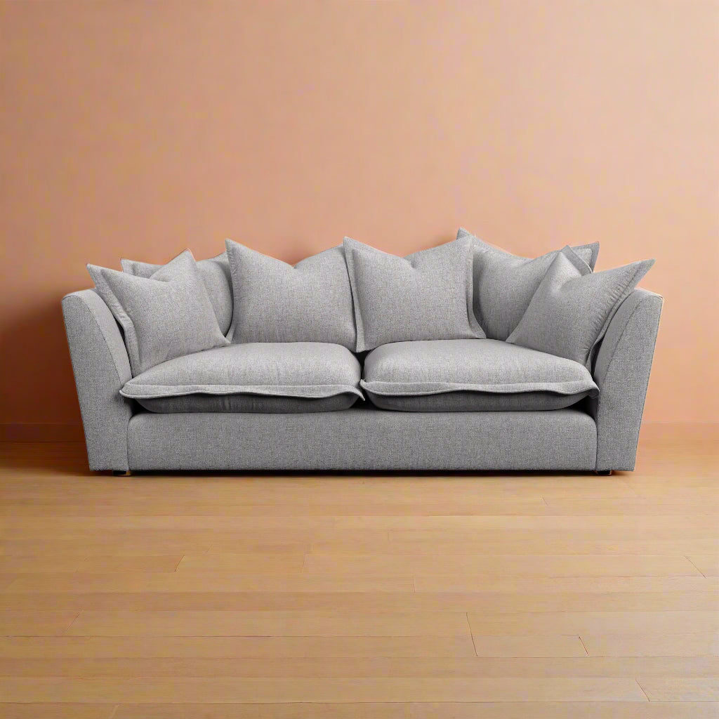Gray sofa with cushions on a white background