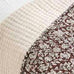 Close-up of a textured fabric with a floral pattern on a neutral background