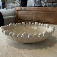 Decorative bowl with spherical design on a stone surface