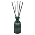 Green diffuser bottle with black sticks on a white background