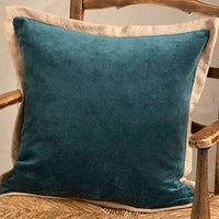 Blue pillow on a wooden chair with a neutral background