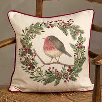 Decorative pillow with a robin design on a wooden chair