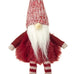 Red and white gnome figurine with a knitted hat on a white background
