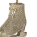 Decorative ice skate ornament with glittery texture and a bow on a white background